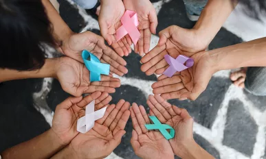 World cancer day. Hands of people holding ribbons